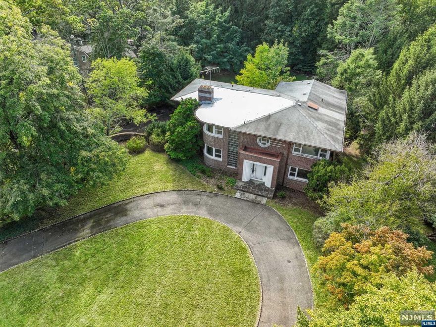 Bring your dreams and vision to make this timeless Old Short Hills Colonial your own! Located on one of the most prestigious neighborhoods. Stately home with low taxes and high architectural integrity, period details and endless potential. Located .6 miles to Short Hills Station, this 5/6 Bdrm, 4 Full and 1 Half Bath home boasts approx. 4300 sq ft of living space (excluding lower level) on lush property. 1st floor with Grand Foyer, formal Dining Rm, Living Rm, Family Rm leads to Sun Rm. Potential for Kitchen of your dreams +Bdrm/Office w/ adjoining Full Bath. 2nd-floor Primary Suite+ 3 more Bedrooms are all connected to full Bath. Full Lower Level w/ steel beam support + attached 3-car Garage. Flat.Please bring your architect, contractor and inspectors prior to submitting an offer. Well built Estate Sale in top rated school district awaiting your updates. Sold strictly AS IS; Seller disclaims express or implied warranty of habitability, and any warranties on property systems.