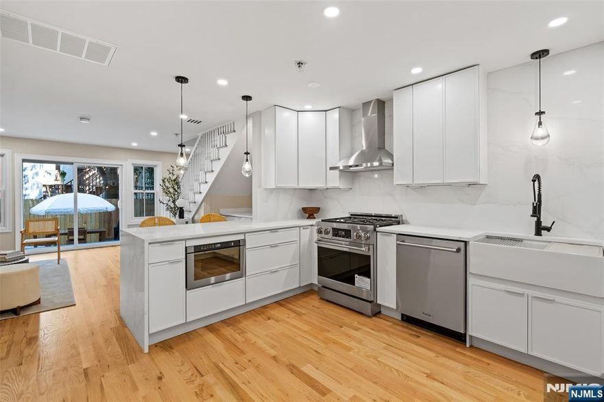 This beautifully designed two-level townhome offers the perfect blend of modern style, comfort, and location in JCâ€™s highly desirable Van Vorst Park neighborhood. A rare first and second floor residence, it lives like a private home while providing the ease of condo ownership and low monthly maintenance. The main level boasts an expansive open-concept living and dining area ideal for entertaining or relaxing, along with a standout kitchen featuring brand-new Thor appliances, sleek cabinetry, and matte black fixtures that bring a contemporary edge. A powder room with in-unit laundry and abundant built-in storage complete this floor, while sliding glass doors open to a private rear yard, a rare outdoor retreat in this neighborhood. Upstairs, spacious bedrooms and spa-inspired bathrooms create a tranquil escape, complemented by freshly refinished hardwood flooring, modern finishes, and a clean, sophisticated palette throughout. Just blocks from scenic Van Vorst Park and surrounded by charming tree-lined streets, the home places you close to top-rated restaurants, local cafes, boutique shopping, and the Hudson River waterfront, with convenient PATH access for an effortless commute to Manhattan. You will appreciate the abundance of nearby school options, including day cares, preschools, and private schools most within a block radius.