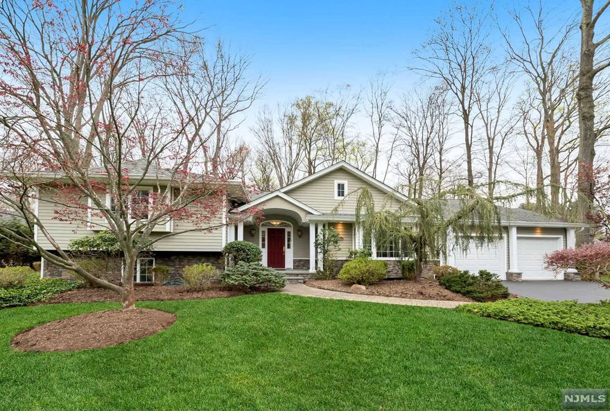 Nothing to do but unpack in this beautifully expanded 4+ bedroom home, renovated from top to bottom in 2004. Wonderful open floor plan with high ceilings and gleaming hardwood floors, this home is perfect for entertaining. Large living room, banquet sized dining room and beautifully updated eat-in kitchen with large center island, breakfast area and French doors to the back patio and gorgeous private yard. A mudroom and powder room with outside access and a 2+ car garage, complete this level. Up just a few stairs, you will find 4 generously sized bedrooms with 3 full bathrooms, including a primary ensuite with a large walk in closet, tray ceilings and its own deck. Laundry conveniently located near the bedrooms. Opportunities in the lower level with exterior access are endless with a large rec room, separate office, possible in-law suite with full bathroom and storage galore. This is not one to be missed with its walkability to top rated schools, parks and transportation.