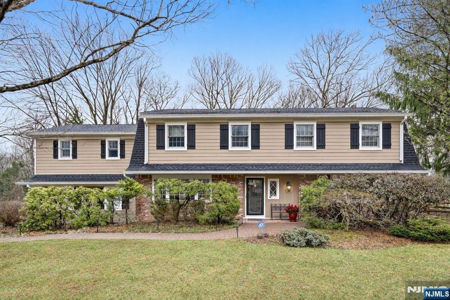 Location, location, location! Set on quiet dead-end street on picturesque property backing to acres of wooded privacy, this expanded and updated Colonial reflects pride of ownership throughout. Entry foyer welcomes you to the warmth and comfort of this 6-bedroom, 3.5-bath home. First floor features a large, sun-filled living room and dining room, a gourmet granite and stainless kitchen with a center island breakfast counter, and a spacious eating area opening to an inviting family room with a wood-burning fireplace. Additionally, youâ€™ll love the spacious mudroom with laundry and a powder room. Upstairs the tranquil primary suite features scenic views of your private oasis, a walk-in closet, and an updated bath. There is a second ensuite bedroom, plus four generous bedrooms and a renovated main bathroom. Enjoy additional living space in the finished recreation room or Retreat to your paver patio with a fire pit and enjoy the serenity of your fully fenced back yard. Close to top-rated schools, the library, and parks.