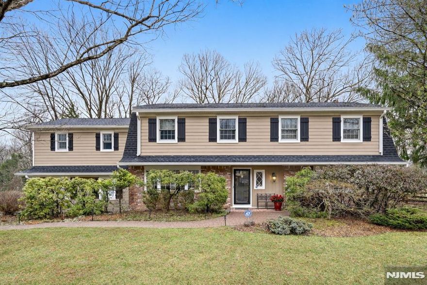 Location, location, location! Set on quiet dead-end street on picturesque property backing to acres of wooded privacy, this expanded and updated Colonial reflects pride of ownership throughout. Entry foyer welcomes you to the warmth and comfort of this 6-bedroom, 3.5-bath home. First floor features a large, sun-filled living room and dining room, a gourmet granite and stainless kitchen with a center island breakfast counter, and a spacious eating area opening to an inviting family room with a wood-burning fireplace. Additionally, youâ€™ll love the spacious mudroom with laundry and a powder room. Upstairs the tranquil primary suite features scenic views of your private oasis, a walk-in closet, and an updated bath. There is a second ensuite bedroom, plus four generous bedrooms and a renovated main bathroom. Enjoy additional living space in the finished recreation room or Retreat to your paver patio with a fire pit and enjoy the serenity of your fully fenced back yard. Close to top-rated schools, the library, and parks.