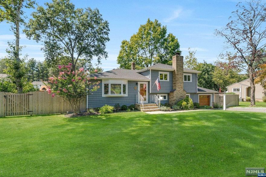 Situated in a desirable neighborhood, this move-in-ready gem offers both comfort and modern living. Sunlight generously bathes the interior, accentuating the gorgeous custom kitchen and pristine wooden flooring. Second floor houses all 3 bedrooms with updated full bath. The versatile lower level accommodates a spacious recreation area, home office space, powder room, laundry and exits to back yard. The fenced yard is beautifully outlined with privacy trees making an ideal landscape for outdoor dining or just relaxing. The paver patio, walkways and expansive deck adjacent to the kitchen complete the tranquil setting. Key upgrades such as a newer roof, siding, air conditioning, and heating system ensure that this residence is not only aesthetically appealing but also equipped for optimal comfort. This home stands as a testament to today's living, ready for its next proud owner.