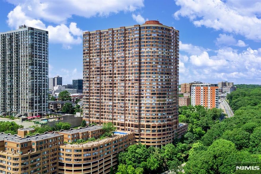 Experience luxurious living in this beautifully updated condo just 20 minutes from NYC. This home features brand-new stainless steel appliances, recessed lighting, elegant wood floors, and fresh paint throughout. Residents enjoy world-class amenities, including 24-hour doorman and concierge service, state-of-the-art fitness center, visitor valet parking, outdoor pool with BBQ area, childrenâ€™s playroom, dog park, and on-site management. Relax in the landscaped courtyard and deck with tables and seating, all while taking in breathtaking NYC skyline views. This residence also comes with two deeded parking spots, offering both convenience and comfort in a prime location.