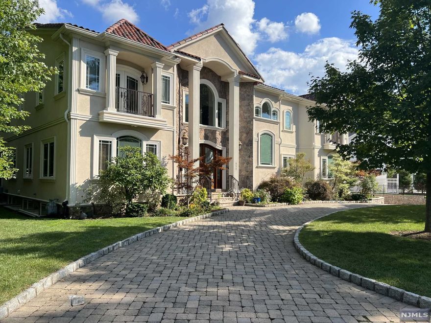 9,000 sqft of pure luxury! Walk up to stunning stone entrance w/dbl mahogany door into your beautiful LR w/vaulted-ceiling w/stunning fireplace. Continue to the library, guestroom, FR & powder room. Custom kitchen w/cherry wood cabinets. Walk to the brkft area, pantry & laundry room. FDR w/custom mahogany buffet. Walk up a stunning cherry staircase or take the cherry elevator to the 2nd fl you'll find 5 bdrms, 3 bths. The MBR has vaulted ceiling, 2 walk-in closets, balcony, MBTH. The North wing features 2 bdrms w/balcony, Jack & Jill bth w/exquisite antique cabinetry & linen closets. The South wing features 2 bdrms, 1 w/balcony, Jack & Hill bth, & linen closet. The lower level boasts an elegant mediaroom w/custom wood finish, wet bar, recreation room, gym, powder room & maids' qrts. Throughout this spectacular home you'll find custom paint & gold leaf trim. This house has a picturesque clay tile roof, circular driveway, & 3 Car garage, covered patio w/gas grill connection.