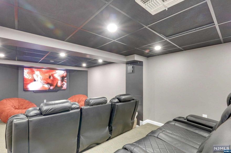 >>Call Listing Agent Anat 201.341.4765<<Nestled in the heart Tenafly's East hill area, this fully renovated home exudes modern luxury. Boasting 4 beds, 3 full baths, and 2 powder rooms, it offers a chef's grade kitchen opening to a family room, perfect for gatherings. A fireplace graces the living room, while a spacious dining room awaits formal occasions. An office on the first floor provides a dedicated area for remote work or study. The master suite dazzles with 2 walk-in closets and a radiant heated floor in the master bath. Upstairs, find another ensuite bed and two more sharing a bath, alongside a laundry room. The lower level hosts a theater and powder room for entertainment. Outdoors, enjoy a bbq and covered patio with fans and heaters. With proximity to schools, worship places, and transit, this home epitomizes comfort and convenience in Tenafly. Features include new hdwd floors, update kitchen and baths , lavish outdoor living as well as tankless hot wtr, ac systems