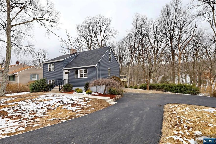 Modern fully renovated inside and out split level on an acre of the lot. Offers brand new septic system. Living room with electric fireplace, eat-in kitchen with ss appliances and island, slider door to the deck, 3 bedrooms and 2 full bathrooms, rec room, laundry and direct access to the yard. Central a/c, brand new windows, roof, hardwood floors, recessed lighting, 2 car garage. Enjoy open backyard with a entertaining deck! Great location, stylish finishes this home is a must-see!