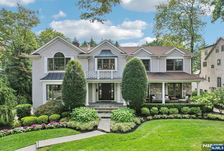 Immaculate Center Hall Colonial on one of Ridgewoodâ€™s most coveted streets in the heart of the sought-after Old Country Club section. Practically new after a 2014 renovation/expansion, this 6-bedroom, 4 full/2 half bath gem offers the ultimate blend of stunning curb appeal, timeless design, and modern class. A grand covered front porch invites you into a light-filled interior with gleaming hardwood floors and effortless flow. Off the entry foyer, a spacious living room links through archways to a family room with a shared double-sided stone fireplace. The open concept continues to the chefâ€™s kitchen with Wolf/Sub-Zero appliances, a custom-built wine bar, and a breakfast nook. A banquet-sized dining room, powder room and bedroom with an adjacent full bath and private entrance round out main level. Upstairs, a loft accesses the luxurious primary suite: vaulted ceilings, fireplace, office, dual walk-ins, spa bath with sauna. Secondary ensuite, 3 more bedrooms, a full bath, and laundry finish the floor. Ultimate entertainerâ€™s basement (finished 2018) includes a versatile rec/media room, half bath, mudroom, and access to the 2-car garage with a Tesla charger. Secluded, flat, fenced yard boasts lush landscaping, bluestone patio with firepit/TV, Trex deck, built-in audio, and weatherproof/wired â€˜clubhouseâ€™ for kidsâ€™ adventures. A Ridgewood masterpiece!