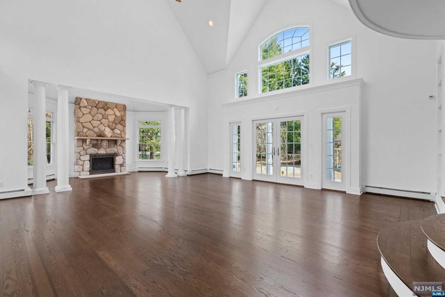 For more info contact Vlad Vojnovski 201-375-1015. Ideally located & much larger than it appears sits this 7432 sq ft colonial nestled upon 1.49 acres. Well-constructed w/ the most sought-after materials & amenities, this home is built to entertain or accommodate a multi-generational lifestyle. The octagonal FDR is steps away from the 2 story LR w/ masonry wood fireplace that opens to the yard. The MEIK w/ custom cabinets, granite tops & new SS appliances opens to the paver patio & tranquil yard. The den leads to the sunlit indoor pool w/ whirlpool & FPL. Life can't be easier with a 1st floor ensuite, office, bonus rm, laundry rm & mudroom. The upper level w/ 5 bedrooms, ensuite & 3 full baths has an exquisite primary BR w/ tray ceiling, stunning Pr. bath along w/ 2 walk-in closets & balcony overlooking LR. Basement has a large finished room along with a potential theatre room & half bath. Utility & storage rooms complete the lower level. Make this exquisite home yours to enjoy!