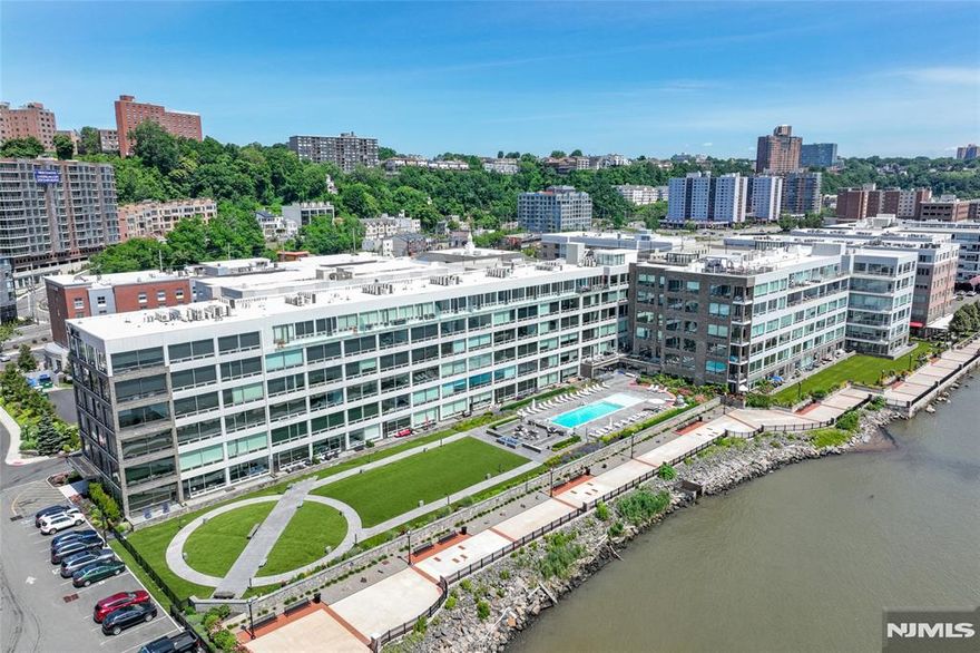 Spacious Luxury 1-Bedroom with Unmatched NYC Skyline Views Experience over 1,000 sq. ft. of sophisticated living with breathtaking floor-to-ceiling views of the Manhattan skyline from every room. This freshly painted home features a modern sliding glass barn door, designer finishes, and the latest in luxury flooring, cabinetry, countertops, and tile work. Enjoy 10-foot ceilings and fully automated security, lighting, and climate control. The gourmet kitchen is outfitted with premium Bosch, Wolf, and Sub-Zero appliances, perfect for any culinary enthusiast. Resort-style amenities include a fitness center, pool, rooftop deck, residentsâ€™ lounge, media screening area with flat-screen TV, and a service bar with refrigerator and sink. Ideally located just steps from waterfront parks, fine dining, and boutique shopping. One indoor parking space included.