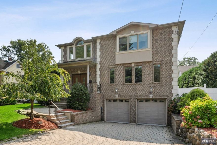 Bright and spacious with lots of storage! Hardwood floors throughout, plenty of natural light, oversized gourmet kitchen with walk-in pantry and bar. Family room with wood/gas burning fireplace, oversized dining room, formal living room, and half bath complete this exceptional first floor. Second floor offers a luxurious master bedroom with gas burning fireplace, vaulted ceiling, master bath, and his/hers walk-in closet. Three additional bedrooms with lots of storage, and Jack and Jill and additional full bath complete the second floor. Full finished basement with mudroom, large recreational room, full bath, laundry room with sink and two car garage. Outdoor oasis provides complete privacy with oversized green giants, mature pear/peach trees, patio, LED lights, sprinkler system, security cameras.