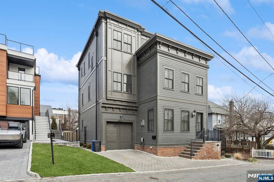 >>>Call listing agent Anat @ 201.341.4765<<<Welcome to 11 Lasher Lane, a magnificent single-family home reimagined to perfection in 2021 on its original foundation. Step inside to an awe-inspiring open floor plan where a stunning gas fireplace anchors the living area, seamlessly flowing into an elegant dining space and a chef's dream kitchen. The kitchen dazzles with an expansive island, luxurious marble surfaces, a sleek paneled refrigerator and dishwasher, and a glass slider opening to a picturesque bluestone patio and pristine fenced yard. The 1st floor also features a stylish powder room, convenient laundry, and garage access. Upstairs, the exquisite ensuite bedroom boasts a spa-like en-suite bath, two generous bedrooms, another full bath, and an airy open space. The 3rd floor unveils a breathtaking primary suite with a bespoke walk-in closet and unparalleled NYC views from the terrace. With a lavishly finished basement, soaring 9.5' ceilings, 7" white oak floors, Marvin windows & doors, and more, this home is a masterpiece of modern living in a prime location!