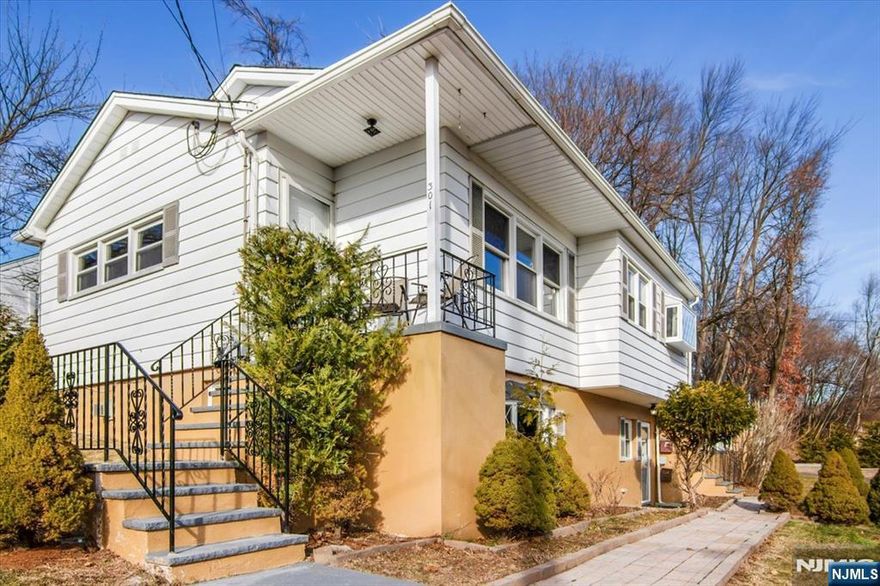 A paver walkway greets you and leads to a lovely open front porch, welcoming you into this beautifully renovated raised ranch for rent on a desirable corner property. The main level is bright and filled with natural light from large windows. The charming eat-in kitchen features chair molding, high-end stainless-steel appliances, wood cabinets, quartz countertops, porcelain backsplash, an adorable picture window, and direct access to the deck. The dining area, with an elegant chandelier, flows seamlessly into the spacious, light-filled living room with a ceiling fan for added comfort. Three bedrooms offer generous closets, a full hall bathroom, and refinished hardwood floors throughout. The lower level includes a huge family room with a gas fireplace accented by a ceramic tile and beautiful flooring, plus an office/media room with outside access, a large full bath with decorative tile and quartz vanity, and a laundry area with newer washer and double-capacity dryer. Additional highlights include central air, recessed lighting, abundant closets and storage and freshly painted throughout in neutral tones. Enjoy outdoor living with a huge paver patio and built-in fire pit, perfect for dining and entertaining. The property also includes a one-car detached garage. Situated in a great neighborhood, only a stone's throw from the NY bus stop, with easy access to shops, restaurants, and more.