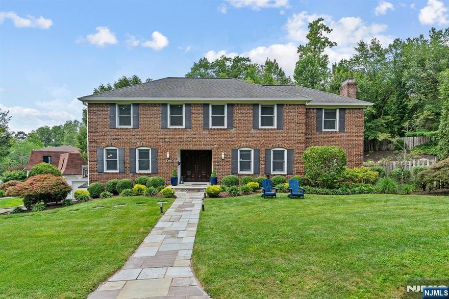 Beautifully maintained brick-front Colonial in a highly sought-after Short Hills neighborhood, just blocks from top-rated Deerfield Elementary. Blending timeless style with todayâ€™s modern comforts, this home offers an open layout ideal for easy living and entertaining. Enter through a stone walkway and double doors into a welcoming foyer with hardwood floors and coat closet. The living room features hardwood floors and the spacious family room boasts two exposures of windows. Front-to-back dining room with a wood-burning fireplace and sliding doors to the backyard. Updated chefâ€™s eat-in kitchen shines with granite countertops, stainless steel appliances, custom cabinetry, built-in desk area and double sliding doors next to powder room opening to an oversized deck with built-in seating overlooking the private, tiered, fenced-in yard. Upstairs, the primary suite impresses with high ceilings, abundant storage including a walk-in closet + spa-like bathroom with double vanity, oversized shower and jacuzzi-style tub. 3 additional bedrooms, each with generous closets and natural light, share 2 full hallway bathrooms. Convenient 2nd floor laundry room adds ease to everyday living. Finished lower level provides a large recreation room, exercise area, office nook, multiple closets for storage, utility room, and direct access to attached 2-car garage. Perfectly located near NYC midtown direct trains, downtown Millburn, the Short Hills Mall and major highways.