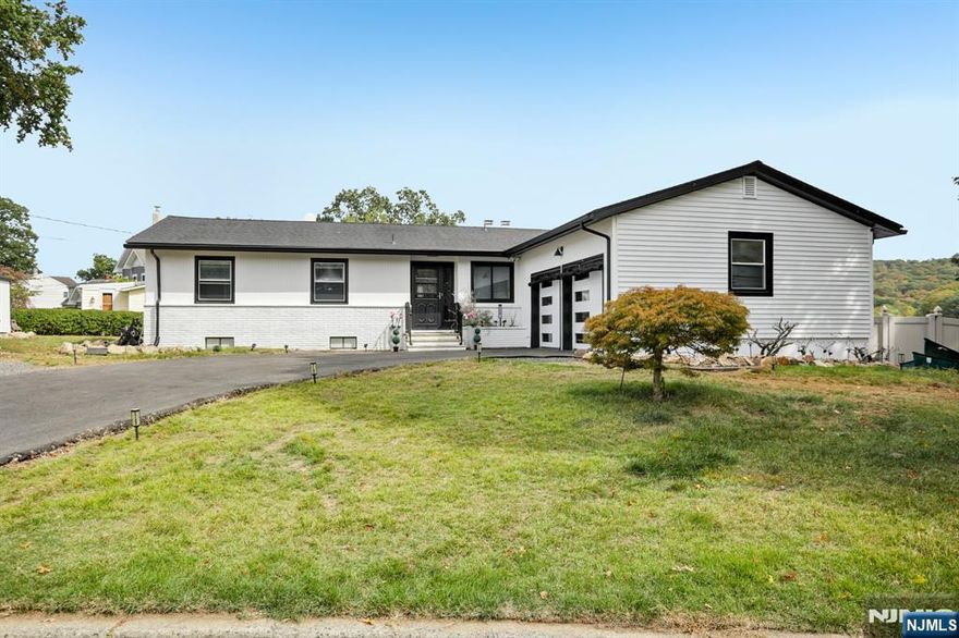 Welcome home to this exceptional 3 bedroom, 3 bathroom open concept Ranch, nestled on an oversized corner lot with what might be the best panoramic lake views in town! Step inside the welcoming foyer and into the stunning living room, where soaring ceilings, wood-burning fireplace, and floor-to-ceiling windows showcase the lake in all its beauty, creating an ambiance of serenity. The open flow continues into the designer kitchen, featuring custom cabinetry, quartz countertops, a stylish backsplash, pantry, and center island with seating. Sliding glass doors extend your living space outdoors to the deck perfect for entertaining or savoring peaceful mornings surrounded by nature. Down the hall, the home offers a spacious primary bedroom with a large closet and opportunity for an en suite, while two additional bedrooms and a full bath complete the level. The full finished walkout basement boasting kitchenette, full bath, family room with soaring ceilings, second fireplace, and bar all framed by breathtaking lake views. Glass doors lead to the patio, gazebo, and fire pit, inviting evenings of relaxation and conversation.Stairs lead down to the water's edge, with the option to add a floating dock for boating, kayaking, or swimming. With a two-car attached garage, detached garage/shed, and ample parking, this residence blends luxury and convenience. Just moments from NYC transportation, shopping, and dining, this home offers an unmatched lifestyle of refined lakefront living.