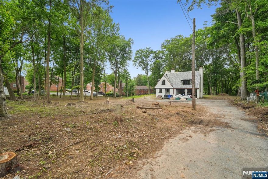 Rare Opportunity in Englewood - Spacious Partially Cleared Lot with Limitless Potential Discover a truly unique property in the heart of Englewood! This expansive partially cleared lot offers endless possibilities for development. Located on a flag lot with driveway access from Central Ave with a possible 175-foot frontage on Knickerbocker Rd. This land is surrounded by well established condo developments on three sides, offering both convenience and a sense of community. While a small branch of Metzler Brook meanders through a portion of the land nearest to Knickerbocker Rd, the majority of the property remains buildable. The charming stream presents an opportunity to create a picturesque setting for any future development. The existing 5-bedroom, 3-bath house on the property is available for sale separately or could be removed upon request. Please note, showings of the house are available by special request only. The primary focus of this listing is the land itself. The buyer will be responsible for securing any necessary permits and zoning applications. Don't miss out on this incredible opportunity for developers, builders, or those seeking to build a luxurious mansion in a highly desirable location. Contact us today for more information on this extraordinary property and let your imagination run wild!