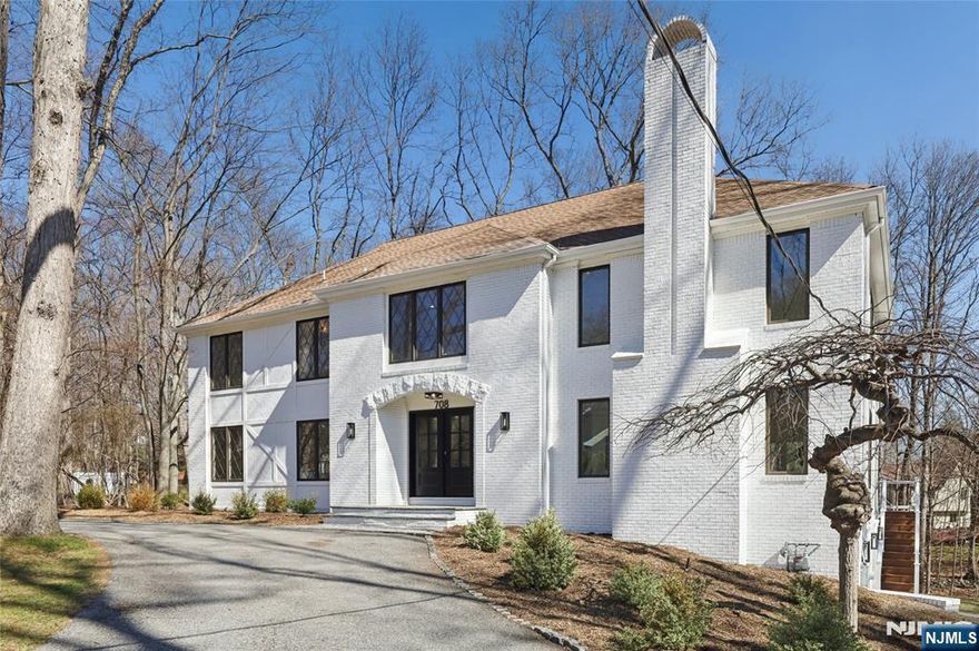 Set on a quiet dead-end street in Franklin Lakes, this fully renovated colonial offers privacy, scale, and standout design. A double French door entry opens to a welcoming foyer that leads into a true great room with double-height ceilings, exposed beams, and a full brick wood-burning fireplace wall. Oversized sliding doors extend the space to a large composite deck, creating seamless indoor-outdoor flow. The kitchen is built for both function and presence, featuring white oak cabinetry, high-end appliances, and a built-in 48â€ refrigerator. Formal dining and living rooms sit just off the main living space, along with a well-designed powder room. Wide-plank 7â€ rift and quartered white oak floors run throughout the home, complemented by abundant natural light from oversized windows. Upstairs, the dream primary suite is positioned for impact and privacy, offering generous proportions, a Juliet balcony overlooking the great room, a huge custom walk-in closet, and a distinctive wet room-style bathroom. Three additional bedrooms, a full bath, and a second-floor laundry room complete the level. The walkout basement adds significant usable space with a massive rec area and soaring ceilings, ideal for a variety of uses. The property is set on a picturesque 1-acre lot with a U-shaped driveway and a charming pond, offering both curb appeal and a unique outdoor setting.