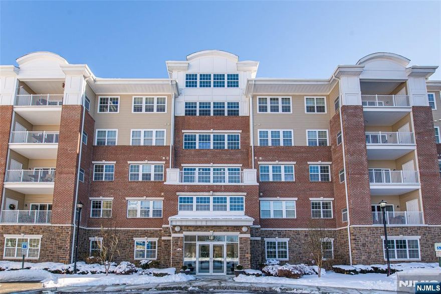 Tucked away in Building 1, unit 1217 at Wanaque Reserve is the finest Colfax model. This stunning condo greets you with custom finishes, a warm color palette, and a Southeast exposure that fills the home with sunlight and offers breathtaking views of the mountain ridge from the large windows and tiled patio. The original owners chose every available upgrade, including hardwood floors, custom window treatments, cherry kitchen cabinets, stainless steel appliances, granite counters, ample storage, and a Nest temperature control system. The home features two spacious bedrooms, a cozy den, a formal dining room, and two large bathrooms. The primary suite boasts an en suite bathroom and walk-in closet, creating a private retreat. Recently painted and carpeted, the unit also includes two prime parking spaces near the garage elevator. Don't miss this perfect blend of style, comfort, and convenience!