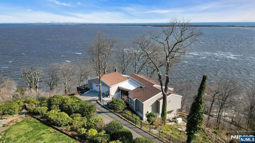 Welcome to your dream retreat - where iconic mid-century modern design meets unparalleled panoramic views. Perched in a prime location of the Atlantic Highlands, this stunning home offers sweeping views of New York Cityâ€™s skyline, the serene coastline of Sandy Hook and the shimmering waters of the Sandy Hook Bay. This architectural allure features clean lines, expansive glass windows, and an inviting, bright and airy layout that seamlessly blends indoor and outdoor living. Wake up to sunrises over the water and unwind with city lights twinkling in the distance - all from the comfort of your living space, or 4 private decks. With direct access to the NYC Ferry, your commute transforms into a scenic escape, offering a rare combination of tranquility and convenience. Whether you're entertaining guests or savoring quiet moments, this home delivers a one-of-a-kind lifestyle. Donâ€™t miss the opportunity to own a true modern classic with a view that never gets old.