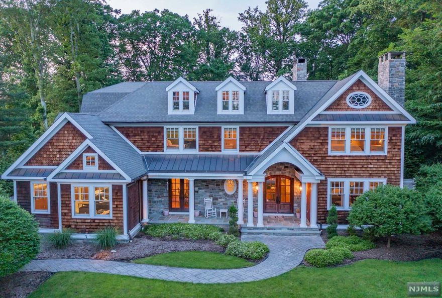 SPECTACULAR HAMPTON STYLE CUSTOM HOME W/CEDAR SHAKE, COVERD FRONT PORCH, BACKYARD OASIS AND AMAZING FINISHED LOWER LEVEL IN PRIME LOCATION. OVER 7500 SQ FT ON JUST 2 LEVELS, GRAND ENTRY FOYER, GORGEOUS HW FLOORS THRU OUT, 7 FIREPLACES & ALL ENSUITE BR'S. NO EXPENSE WAS SPARED IN THE DESIGN & BUILD OF THIS YOUNG HOME. CUSTOM MILL WORK THROUGHOUT. LR W/FP, BANQ DR, GRT RM W/BLT INS, STONE FP. CUSTOM LBRY/OFFC W/FP, BLT INS AND SEP ENTRY. OVERSIZED KITCH W/HIGH END APPLNCS, BTLRS PANTRY & BKFST RM W/PRIV ENTRY. 2ND FAMILY RM W/ BEAMED CLGS & FP, MUD RM, BACK FOYER & 2 PR'S COMPL THE 1ST FL. THE PRIM SUITE IS YOUR OWN PRIV RETREAT W/LUX BTH, 2 FP'S, CUSTM CLOSET & VANITY AREA, TERRACE OVERLOOKS STUNNING PROPERTY.4 ADDT'L BR'S LARGE & ENSTE, LNDRY. LWR LEVEL IS A DREAM W/GYM, FAM RM W/FP, FULL BATH, WINE CELLAR, GAMING RM & REC RM. STEP OUTSIDE TO MULTI PATIOS, CUSTOM POOL & SPA. THE HIGHEST QUALITY FINISHES CAN BE FOUND THROUGHOUT. YOUR DREAM HOME & PROPERTY!