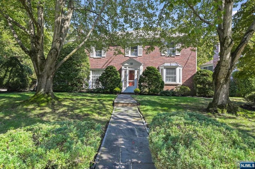 Located on a beautiful half acre on Tenafly's coveted East Hill, this stately center hall colonial boasts a classic design on an exceptional property. As you step inside the foyer, you'll be impressed by the elegant living room with fireplace that opens into the sun-filled den/office. A formal dining room leads to the bright kitchen which opens to the inviting family room with a fireplace. French doors open to the bluestone patio that overlooks the private and manicured grounds. A primary suite, three additional finely proportioned bedrooms and a full bath complete the second floor. There is a full basement with a recreation room, laundry room and plenty of storage. This residence exudes quality throughout from the brick exterior and slate roof to hardwood floors and fine trimwork and mouldings. A sophisticated and welcoming home within a block to NYC transportation and a short walk to fine dining, shopping, recreation and Smith School. Just minutes to NYC, yet a world away!