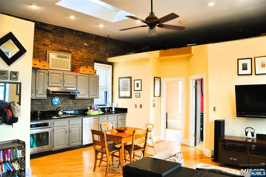 Welcome to 163 14th Streetâ€”a well-maintained corner building in Hobokenâ€™s highly desirable uptown neighborhood. This top-floor, corner one-bedroom apartment is filled with natural light from its south and west exposures, plus a skylight that enhances the homeâ€™s airy ambiance. The residence offers a generous open-concept layout with hardwood floors throughout, soaring ceilings, and exposed brick that adds character and warmth. The open kitchen offers stainless steel appliances and ample cabinet space, while the bathroom features both a separate bathtub and shower stall. Additional highlights include two decorative fireplaces, in-unit washer and dryer, wall-mounted air conditioning units, and an expansive lofted storage area. Situated just steps from the NYC bus, 14th Street ferry, Trader Joeâ€™s, and some of Hobokenâ€™s best restaurants, cafes, and shops, this home offers unbeatable accessibility and charm. A parking garage is conveniently located one block away on Bloomfield Street. Rent includes heat and hot water. Avail DEC 1 - no pets, no smoking.