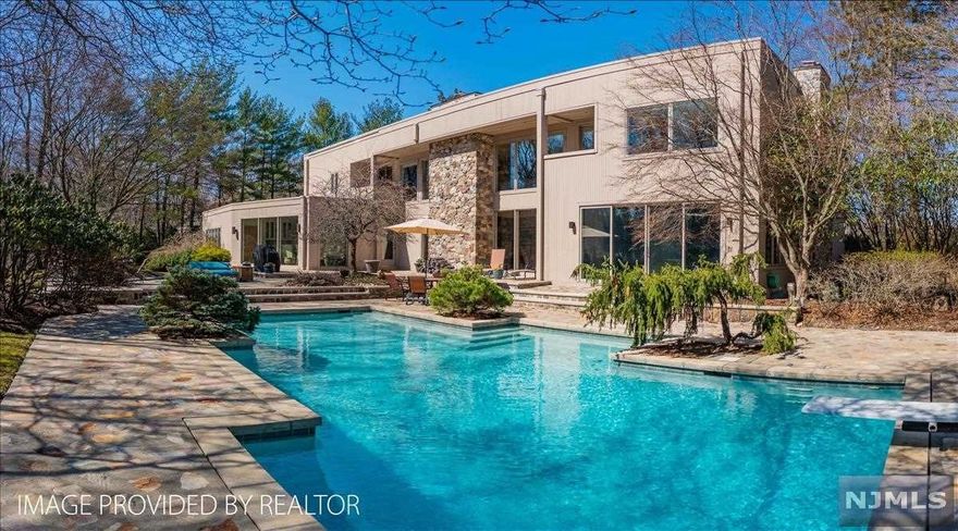 Elements of light and space combine in dramatic fashion in this sophisticated contemporary retreat. With five bedrooms and 6-1/2 bathrooms, including a first-floor bedroom with en-suite bath, this almost 7,000 square foot home lends itself perfectly to a versatile lifestyle. Boasting a highly sought after home office with private entrance, plus a finished lower level, this residence will easily become your forever home. Outside, ornamental trees and shrubs dot the landscape, which is anchored by an inviting Gunite pool, and bordered by a meadow, and protected, natural woodlands. Located at the end of a cul-de-sac, this location provides ultimate privacy with the convenience of proximity to all of Franklin Lakes' offerings, including the Indian Trail Club, Market Basket, and the Nature Preserve, and all within 30 minutes of NYC.