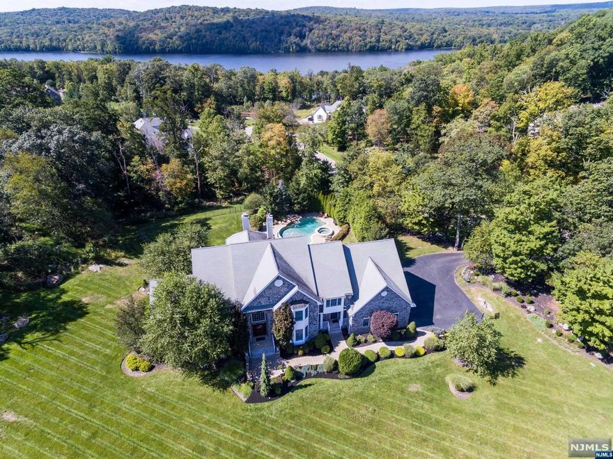 Welcome to this Amazing 5 Bedroom, 5 & 1/2 Bath Retreat Custom Home in Grandview Estates set on 1.762 acres. Custom Moldings and Millwork through-out. Modern Eat-in Kitchen with Center Island, Living Room, Dining Room, Office with Coffered Ceiling, Large Conservatory with Hand Crafted Bar & Ample Windows. Two Story Great Rm with Stone Fireplace, Primary Bedroom with Gas Fireplace, Walk-in Closet and Primary Bathroom. Guest Room or 5th Bedroom with Ensuite & Separate Entrance. Fin Walk Out Lower Level with Rec Room, Wet Bar, Billiard Room, 2nd Office or In-Law Suite with full Bathroom. Backyard Oasis with In-ground Gunite Saltwater Pool with Waterfall & Spa. A Custom Out-Door Kitchen with a Gas Grill, Refrigerator, Stone & Granite Bar & a Custom Stone Fireplace for those Cool Evenings. 20 Kilowatt Generac Generator & 3 Car Garage.