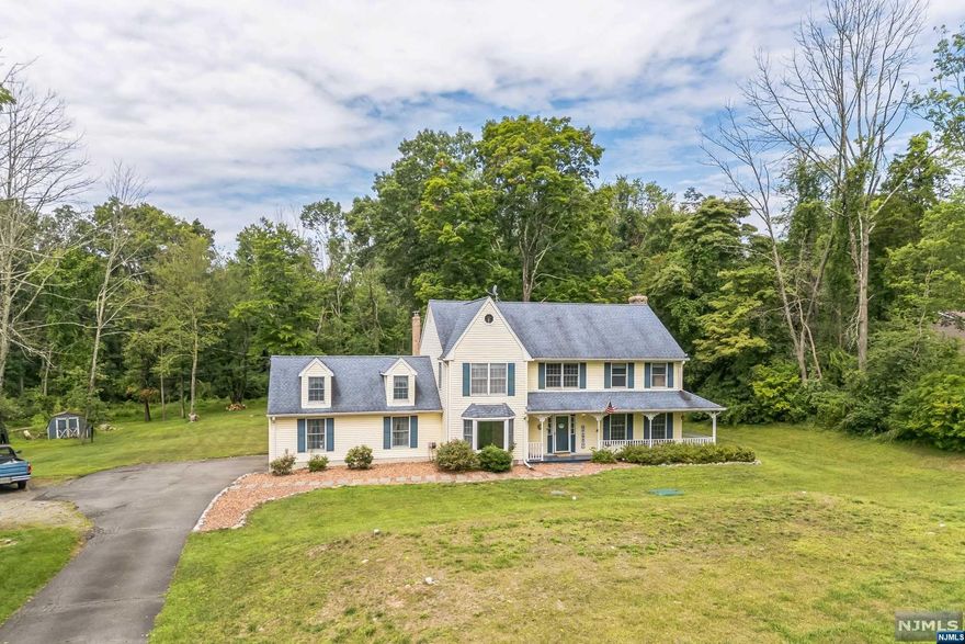 Welcome Home! Center Hall Colonial with Lemonade Porch! The First Floor offers generous, well-connected spaces, including a Formal Living Room, Formal Dining Room, Eat-in Kitchen with a Walk in Pantry, a Family Room with a Wood-Burning Fireplace, Powder Room, and a Laundry Room. There is also access to the Garage and the Sprawling 2+ acre FLAT backyard. Upstairs, the home has Four Bedrooms and a Full Bathroom. The Primary Bedroom has a Walk-In-Closet and an Ensuite with Soaking Tub and Shower.The expansive backyard has endless possibilities for outdoor entertaining and relaxation. New Septic System installed in 2023! Minutes to Route 80- great location for commuters. Don't miss this opportunity to make this country home yours!