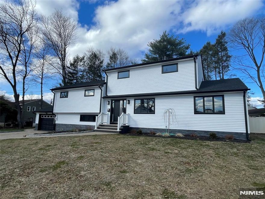 Updated Contemporary Split Level Home on large fenced-in park-like property. The Bright Entry hall of this home leads to the Living Room with hardwood floors, open to a new kitchen with stainless steel appliances and quartz countertops. The Dining Room is open to the Family Room with a new full bathroom. The 2nd level features a large Bedroom with along with new half bath. There are 2 more bedrooms and another new full bath. The 3rd floor has a Primary bedroom with Full bath. The lower level of this Contemporary home features another Family room and half Bath. All just a few feet away from the heated in-ground pool. New siding, new roof, and ew deck. New A/C. Large paver driveway. All this and low taxes! Close to all major malls and highways.