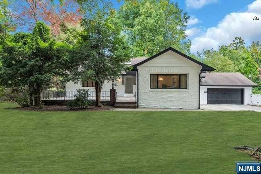 Private and conveniently located near downtown Cresskill, this Ranch-style home sits on a .6174-acre lot, surrounded by towering trees. The property boasts a beautifully renovated gunite pool, perfect for summer relaxation, and a wrap-around driveway with access from quiet Merritt Ave. Inside you will find an airy living and dining room, ideal for entertaining. The kitchen features an adjoining bonus room, perfect as a family room, office, or whatever you desire. Two additional bedrooms and a full hall bath complete the main level. New floors in all the bedrooms. The fully renovated, NEW, lower level adds significant living space, featuring a gas fireplace, bedroom, full bath, laundry, and walk-out access to the backyard. Step outside to a large deck overlooking the private yard, with ample space to entertain and enjoy the updated pool. Your own little oasis. This home offers privacy, room to play, and endless potential. just waiting for your personal touches.