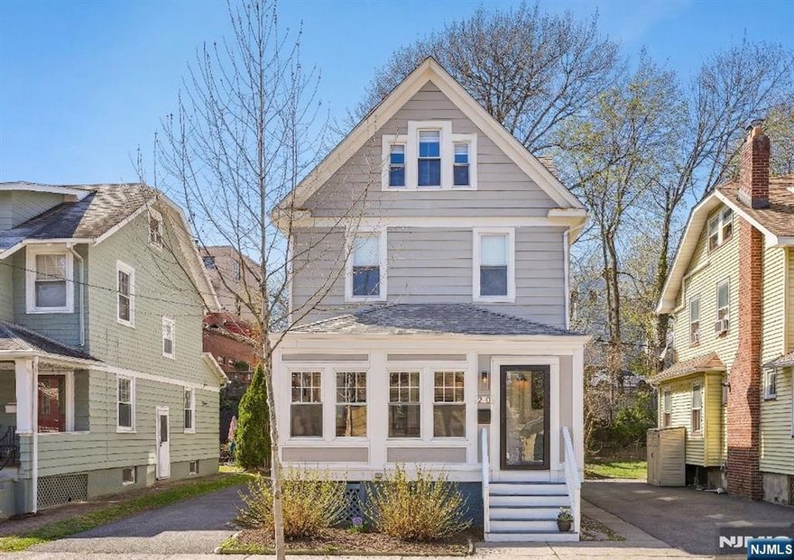 Nestled on a tree-lined street, this beautifully renovated 4-bedroom, 3.5-bathroom Colonial offers the perfect blend of timeless architecture and high-end modern amenities. The bright, open-concept main floor transitions from a sunroom and inviting living area to a modern kitchen and dining space, complete with quartz countertops and stainless steel appliances. Sliding doors open to the paver patio and yard with a projector screen for outdoor movie nights. Don't miss the stylish powder room before you head upstairs! The primary bedroom boasts generous closets and a spa-like ensuite bathroom with a double vanity and a glass-enclosed shower. The second floor features two additional bedrooms and a second full bath, also with a spacious double vanity. Ascending to the top level, the floor opens into a versatile office nook, a fourth bedroom and a sophisticated, luxe full bath. Gleaming hardwood floors, central air, energy efficient windows and recessed lighting throughout. Plus the unbeatable location! Skip the car and enjoy the best of the neighborhood. Whether you're grabbing your morning coffee at a local cafe, dropping the little ones to school or catching the express train to NYC, everything you need is within reach. Don't miss the opportunity to own this turn-key masterpiece. Schedule your private showing today!