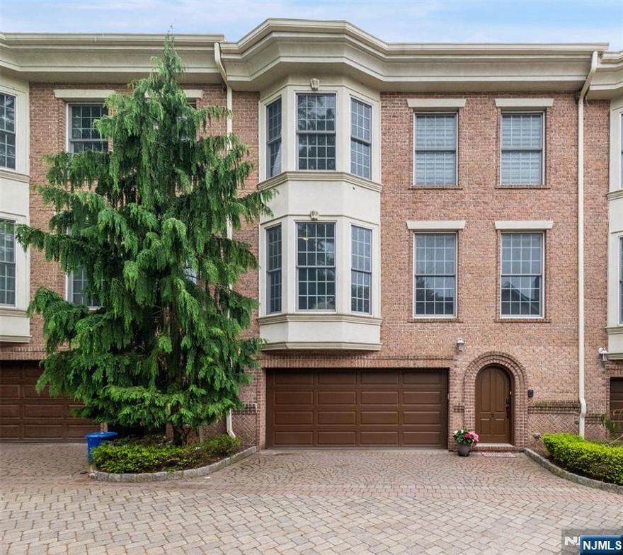 Welcome to this beautifully designed brick townhouse in a private, luxury 5-unit complexâ€”just minutes from the heart of Fort Lee. With a private paver driveway and 2-car garage, this home offers both convenience and style. Step into the elegant foyer and ascend to a spacious main level featuring soaring 10-foot ceilings and a bright, open floor plan. The east-facing living room is filled with natural light and anchored by a dramatic floor-to-ceiling custom-built-in and a cozy fireplace. The oversized eat-in kitchen is a chefâ€™s dream, equipped with high-end stainless steel appliances, granite countertops, and ample cabinetry. The kitchen seamlessly flows into the dining area, ideal for gatherings. A stylish powder room completes the main floor. Upstairs, you'll find three generously sized bedrooms, including a luxurious primary suite with a spa-inspired bathroom. Indulge in the deep soaking tub filled by a ceiling-mounted spoutâ€”a true retreat. Two additional sun-drenched bedrooms, a large skylit hallway bath, and a laundry area round out the upper level. Additional highlights include gleaming hardwood floors throughout, elegant crown moldings, and exceptional craftsmanship at every turn. This home blends comfort, luxury, and convenienceâ€”all in one of Fort Leeâ€™s most desirable locations.The seller needs U&O for up to 2 months.
