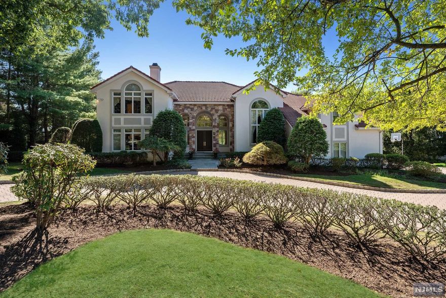 Luxurious Contemporary Colonial encompasses 6 bedrooms, 5 and a half bathrooms, and an attached 3-car garage on nearly an acre of manicured property. Situated on a quiet cul-de-sac, this stunning home is just a twenty-minute drive to Manhattan and close to shopping, dining, parks, and major highways. A stone paver semi-circular driveway and impressive arched entryway bring you inside to a 2 story foyer opening to the large family room w/ soaring floor-to-ceiling windows w/ an elegant gas fireplace, formal living room, elegant dining room, gourmet eat-in kitchen, sun-washed breakfast nook, powder room, an office, laundry room, bedroom, full bathroom, access to the garage, and an outside entrance. The second floor comprises a luxurious primary bedroom suite, a sitting room with a spiral staircase to the first floor office, a walk-in closet, and a lavish en suite bathroom, 3 additional bedrooms & 2 baths, This home has so much more to offer, you need to see it to believe it!