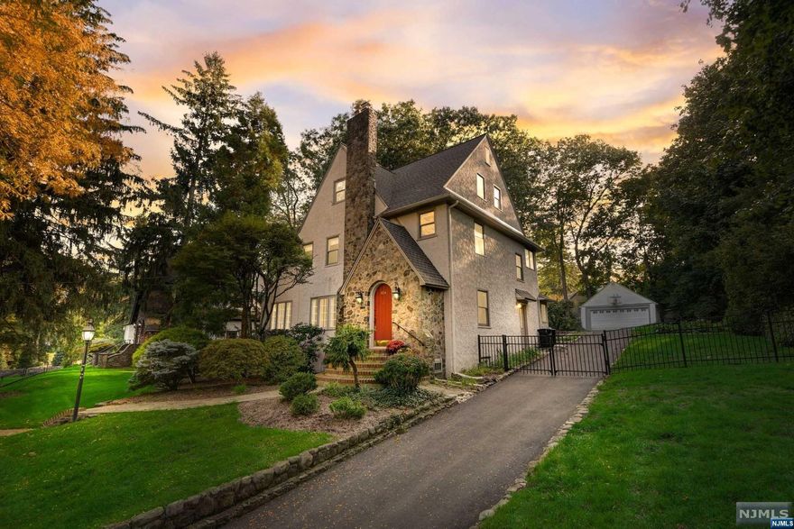 Meticulously maintained Upper Ridgewood Tudor offering the perfect blend of timeless elegance, suburban tranquility, and modern-urban convenience. Nestled on a half-acre, this 4 bedroom, 4.5 bath home is recently upgraded with a new roof, boiler, smart home features, carpeting, light fixtures, washer/dryer, and built-in Al Fresco grill. With 4,000SF of seamlessly flowing living space and a traditional colonial layout, this home is perfect for entertaining & everyday living. On 1st level is a chef's kitchen overlooking a light-filled vaulted-ceiling family room with fireplace, formal dining room, and living room with French doors & fireplace. Primary suite, 2 bedrooms, and shared hallway bath on 2nd level, and an office, 4th bedroom & bath on 3rd level. Completing the home is a finished basement with fireplace, private fenced backyard & 2-car garage. Located just moments from Willard ES., the train to NYC, and downtown Ridgewood & Ho-Ho-Kus. Move right in!