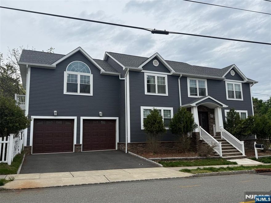 Welcome to this custom Colonial offering over 3,500 sq ft of living space and situated on a desirable corner lot in the heart of town. This home features an open floor plan with a spacious Living room w/fireplace and directly flows into the Dining room that opens to the Modern Eat-in kitchen with quartz countertops and large center island. Convenient Powder room completes the first level. Second floor offers a large Master Bedroom with sliders to a private balcony overlooking the backyard, a walk-in closet, and Master Bath with jetted tub, along with four additional Bedrooms, Laundry room, and full Bathroom. The fully finished Basement provides a spacious Family room and plenty of space for a Rec room, Playroom, Office, or home Gym. Additional highlights include multi-zone heating, central air, large fenced yard with private picuzzi that is just perfect for entertaining, and two-car attached Garage with additional driveway parking. Prime location close to parks, schools, shopping, dining, major highways, and NYC transportation.