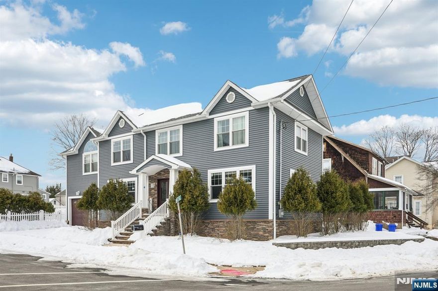 Welcome to this custom Colonial offering over 3,500 sq ft of living space and situated on a desirable corner lot in the heart of town. This home features an open floor plan with a spacious Living room w/fireplace and directly flows into the Dining room that opens to the Modern Eat-in kitchen with quartz countertops and large center island. Convenient Powder room completes the first level. Second floor offers a large Master Bedroom with sliders to a private balcony overlooking the backyard, a walk-in closet, and Master Bath with jetted tub, along with four additional Bedrooms, Laundry room, and full Bathroom. The fully finished Basement provides a spacious Family room and plenty of space for a Rec room, Playroom, Office, or home Gym. Additional highlights include multi-zone heating, central air, large fenced yard with private picuzzi that is just perfect for entertaining, and two-car attached Garage with additional driveway parking. Prime location close to parks, schools, shopping, dining, major highways, and NYC transportation.