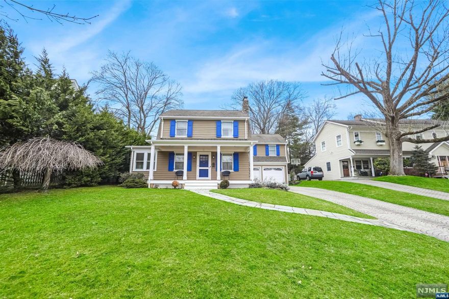 This 1927 Dutch colonial w a large addition. Home features a covered newewr sitting porch, large sunny LR with fireplace, FDR, office/sun porch, tiled kitchen with granite counters, subway tile backsplash, and SS appliances. The second floor has a Primary Bedroom suite with WIC, bath with double corian sinks, jetted tub and skylights. The second floor has three additional large bedrooms, full hall bath, and a laundry room. 2 care garage. New Hot water heater