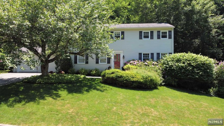 Beautiful center hall colonial in Ringwood Acres! Very well maintained 4 bedrm home with public sewer and water. Gorgeous, private backyard with fenced in-ground heated pool! The precious landscaping and surrounding trees makes you feel like you are at the Botanical Gardens. Cherry kitchen with ss appliances and pantry. Formal dining room, spacious living room and family room with wood burning brick fireplace. Beautiful hardwood floors throughout. Bathrooms renovated. Two zone gas baseboard heat. Owner bedroom with updated bath and walk-in closet. 3 more bedrooms and main bath on second floor. Full unfinished walk-out basement with plenty of storage. Very desirable neighborhood, easy access to skyline drive and highways! Just 4 miles to Bergen County. Bus transit to NYC. Beautiful home in a beautiful town that offers plenty of hiking, lakes and recreation for all..