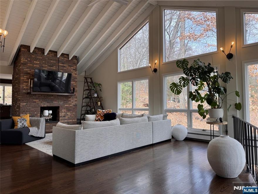 Custom built contemporary 4500+ SF on private wooded 1.5 acre lot. Dramatic floor to ceiling windows, beamed cathedral ceilings to an open layout dining / living space. Nice sized kitchen with a breakfast nook that leads you out to your own fenced in forested retreat right here in Bergen County! Designated office/ den right off the living room. The home offers 3 great sized bedrooms along with a large spacious primary bedroom. Newly updated HUGE ground level rec room with wet bar, half bath to do as you please. The home can be rented furnished if desired for an additional fee. Small pet may be considered. Shorter/ longer term may be considered.