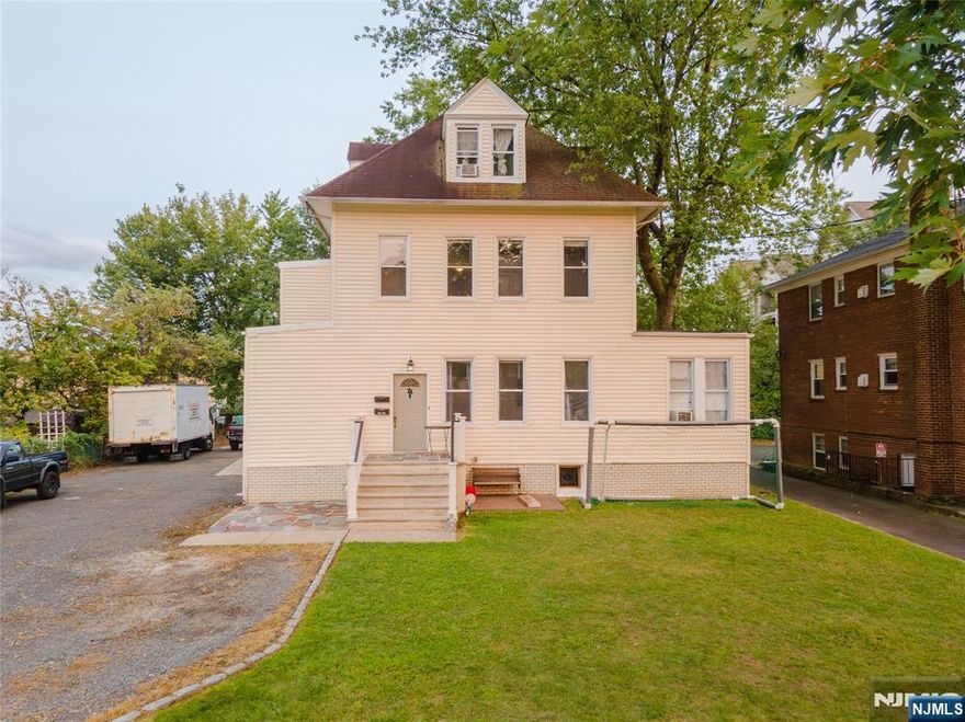 Spacious two-family home in the desirable Hilton neighborhood of Maplewood. The first-floor unit features 3 bedrooms, 1 bath, a large living room, and a beautifully updated kitchen with center island. The second-floor unit offers 2 bedrooms and 1 bath, plus a finished attic with 2 additional bedrooms and full bath, with a separate entrance. Both kitchens are well-appointed with generous cabinetry and counter space. High-ceiling basement provides ample storage and laundry area. Expansive driveway accommodates up to 15 cars. Excellent opportunity in a vibrant Maplewood community close to schools, shops, parks, and transit.