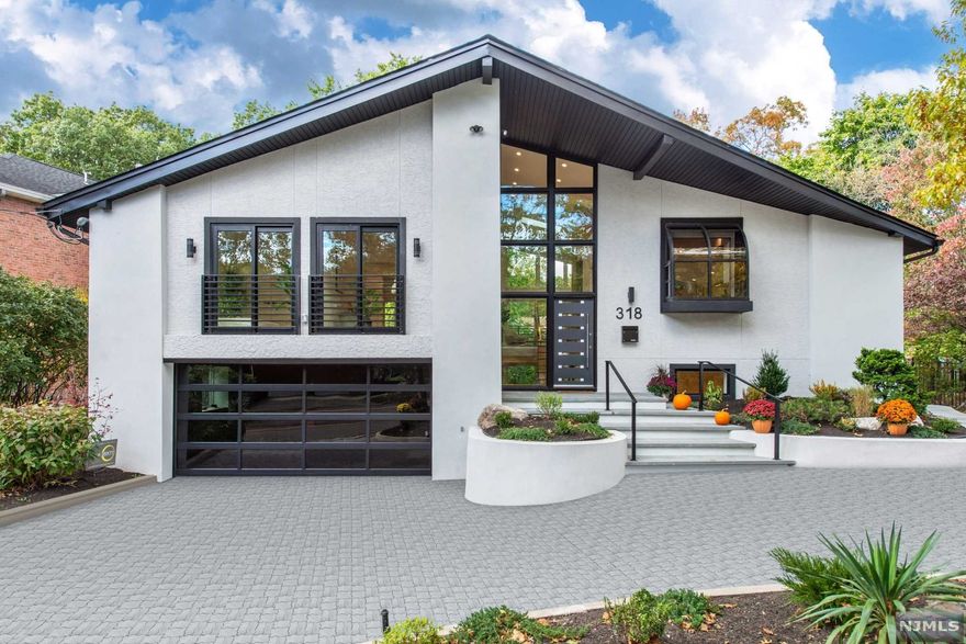 Every inch of this contemporary gem has been meticulously renovated using the highest-quality materials, craftsmanship, and interior design aesthetic. 4 beds, 3 full baths custom design in the sought-after Englewood Cliffs. Enter through the custom European door into a sunlit open floor plan with clean lines with modern details throughout. 1st level boasts oversized formal living/dining room, Chef's kitchen w/ Italian quartz center island. New kitchen appliances including Wolf appliances & wine cooler. Master suite featuring walk-in closets, master bath/spa w/his & her shower, smart mirrors, heated floors & TOTO bidet. Downstairs where you will find the full, finished lower level featuring a rec room, sauna & sunroom room w/access to backyard. Large living room, bedroom w/oversized closets, full bath and laundry room with plenty of storage space. The methodically manicured backyard is perfect for relaxing with an in-ground swimming pool and cover patio.