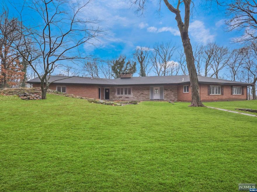 Stunning Ranch style home in Pompton Lakes on over 3.5 acres of land! Enter into the open concept dining room and sunken living room with large windows that overlook the beautiful property. Dining room flows nicely into the brand new kitchen featuring Quartz countertops, custom cabinetry, stainless steel appliances, center island with bar stool seating & separate dining area. Porcelain floors run throughout the entire main living area. Updated powder room and laundry room with slop sink are located just off of the kitchen. The primary suite offers spacious bedroom with ample closet space and gorgeous en suite with dual vanities, free standing soaking tub and stall shower with seamless glass enclosure. The main floor offers 3 additional bedrooms and a full bathroom with tub shower and storage vanity. The finished basement offers a den w/ gas fireplace, storage room and full bathroom with stall shower. Retreat outside to the backyard patio area, which leads you to the inground pool