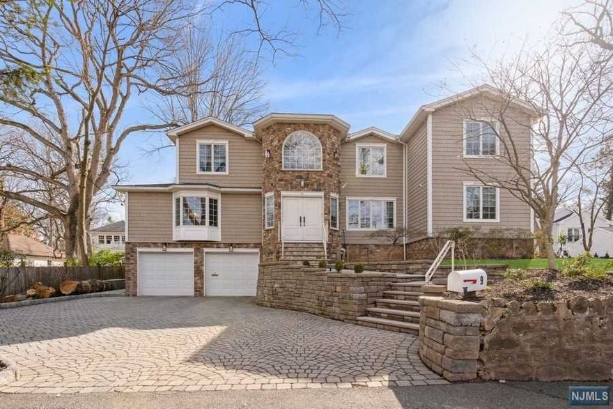 Less than 10 miles from NYC & situated on a cul-de-sac on Tenafly's East Hill, this custom renovated home offers a bright 2 story foyer welcoming you w/formal living rm & large dining rm flowing perfectly to great room and eat-in kit. Kitchen is fitted w/top of the line stainless steel appliances, large center island, stone countertops, wine bar, & built-in breakfast table, & is open to the oversized great rm w/modern fireplace & moldings, and a wall of windows. Also on 1st floor, P/R, office/bedroom, guest bedroom, full bath & laundry. 2nd floor opens to stunning master w/gas fire, luxe spa-like bathroom w/radiant floors & huge walk in closet. In addition, 3 large BRs and a full bath. Full finished basement offers bedroom, full bath, large rec, kids club house, mud & heated 2 car garage. Outdoor oasis w/ built-in gourmet kitchen w/an Argentinian BBQ, built in firepit and space to play & entertain. Hardwood floors, surround sound & security throughout plus full house generator.