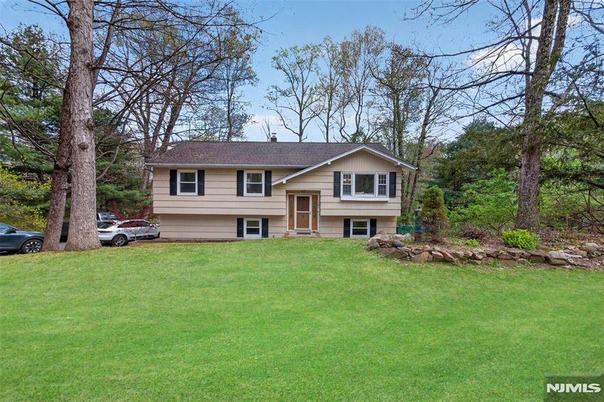 Charming Newly Renovated Bright Lovely 3BR 2BA Idyllic Home Close to Everything & Surrounded by Nature. Enter the two-story foyer and take a few steps, your view focuses on the warm inviting living room filled with natural light. Enjoy sweeping views of the back lawn and surrounding woods below from the large dining room and open modern kitchen featuring stainless steel appliances, granite countertops, full size island with breakfast bar. A spaciousbright primary bedroom, gorgeous full bath along with two other bright bedrooms complete the upper level. Lower level offers a large family room, withsliding door access to the large patio and serene backyard, office/bonus room also with access to the backyard, laundry room, and 1 car attached garage. Plenty of parking is available in the driveway. Conveniently located near shopping, restaurants, hospitals, and major highways. NOTE: Home is in coveted MOUNTAIN LAKES HIGH SCHOOL district!!!
