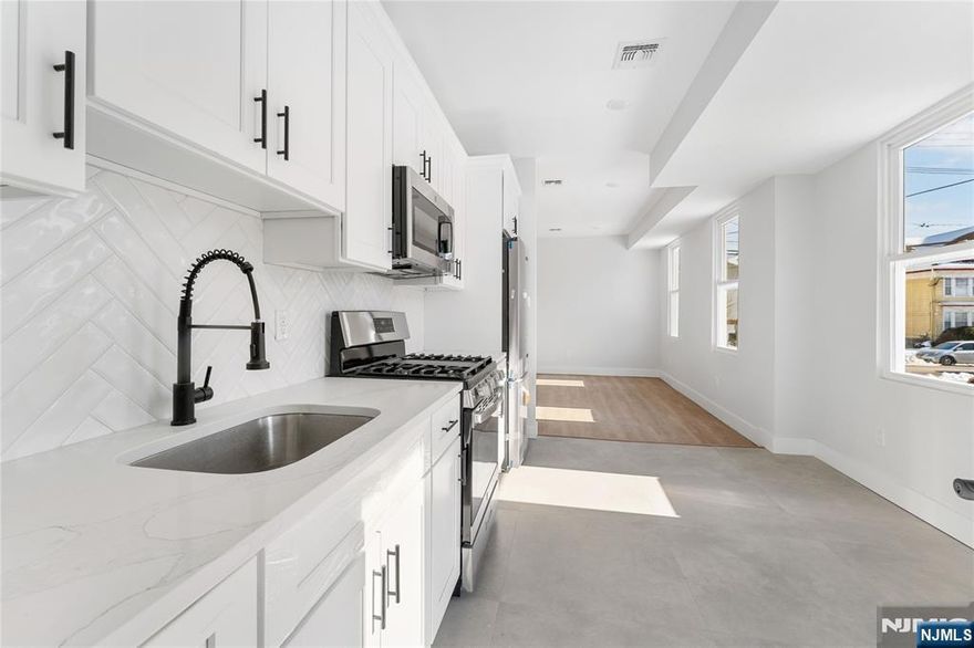 Newly built 3-family property offering a 5 Year Abatement!!! This is a turnkey investment opportunity in a prime commuter location near NYC bus lines and train station. Designed with modern living and long-term durability in mind, this multi-family delivers quality craftsmanship and brand-new finishes throughout. The property features a total of 9 bedrooms and 5 full bathrooms across three thoughtfully designed units with 9-foot ceilings that enhance natural light and create an open, contemporary feel. Each unit includes modern kitchens and bathrooms with new cabinetry and fixtures, as well as dedicated in-unit laundry for added convenience. Built for comfort and performance, the property includes newly installed HVAC, electrical, plumbing, and mechanical systems. Double insulation and soundproofing between units provide enhanced privacy and energy efficiency. A finished basement with a full bathroom adds additional flexibility and functional space. Two garages with parking capacity for up to six vehicles offer a rare and valuable amenity for both tenants and owners. Ideal for an owner-occupant seeking to offset expenses with rental income or an investor looking to add a low-maintenance, income-producing asset in a strong commuter market.