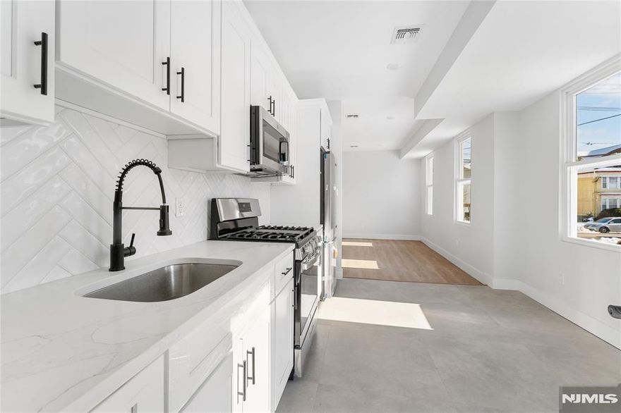 Rebuilt 3-family property offering a 5 Year Abatement!!! This is a turnkey investment opportunity in a prime commuter location near NYC bus lines and train station. Designed with modern living and long-term durability in mind, this multi-family delivers quality craftsmanship and brand-new finishes throughout. The property features a total of 9 bedrooms and 5 full bathrooms across three thoughtfully designed units with 9-foot ceilings that enhance natural light and create an open, contemporary feel. Each unit includes modern kitchens and bathrooms with new cabinetry and fixtures, as well as dedicated in-unit laundry for added convenience. Built for comfort and performance, the property includes newly installed HVAC, electrical, plumbing, and mechanical systems. Double insulation and soundproofing between units provide enhanced privacy and energy efficiency. A finished basement with a full bathroom adds additional flexibility and functional space. Two garages with parking capacity for up to six vehicles offer a rare and valuable amenity for both tenants and owners. Ideal for an owner-occupant seeking to offset expenses with rental income or an investor looking to add a low-maintenance, income-producing asset in a strong commuter market.