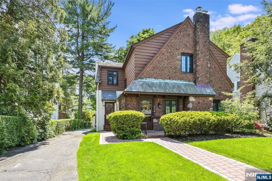 You'll be impressed by this lovingly maintained Tudor home located in the sought after Manor section of Englewood. From the artistic brick, stucco, and cedar exterior with slate roof, to the authentic hardwood floors, and new central air, this house is a treasure. Step into the sunken LR w/fpl and 11ft beamed ceiling, which leads to the FDR and charming EIK with SS appliances, quartz counters, birch cabinetry, and breakfast nook. Den opens out to a flagstone upper patio w/wrought iron railing, leading to a lower-level flagstone patio overlooks the property, perfect for outdoor entertaining. A large primary bedroom, two additional bedrooms and a FB complete the 2nd floor. Finished bsmt offers office/family room, laundry room, and storage. This is a rare opportunity to acquire an exceptionally maintained and pristine home in one of Englewood's most coveted neighborhoods.