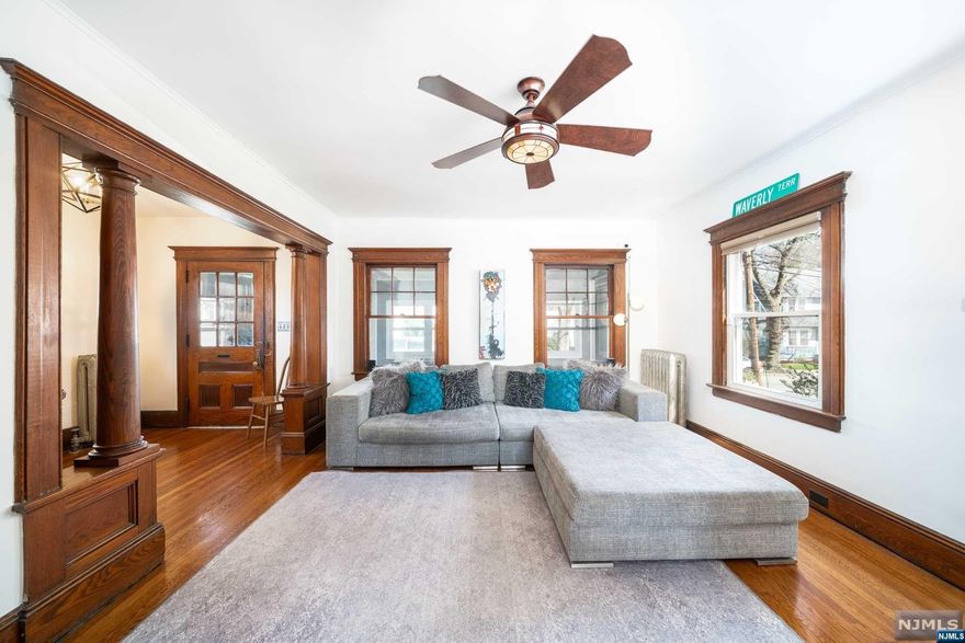 This captivating colonial residence seamlessly blends classic charm w modern comforts 3BR/1.5 baths. Its spacious living & dining areas, adorned with original woodwork, a decorative fireplace, & hardwood floors & mini split ac system, effortlessly accommodate gatherings. Sliding doors open to the patio, enveloped by an evergreen garden, while the serene front porch offers a perfect spot for morning coffee. The eat-in kitchen boasts white cabinetry, brick-patterned backsplash, & modern appliances. Upstairs, 3 bedrooms & a renovated main bathroom exude contemporary elegance with subway tiles, penny floor tiling & gold fixtures. The main bedroom features reclaimed wood decor & a walk-in closet. With upstairs Central A/C & ceiling fans ensure year-round comfort. The attic & basement offer versatile usage, while smart home upgrades enhance convenience. An oversized garage & driveway parking for 2 cars provide ample storage & easy access to nearby shops, transportation options