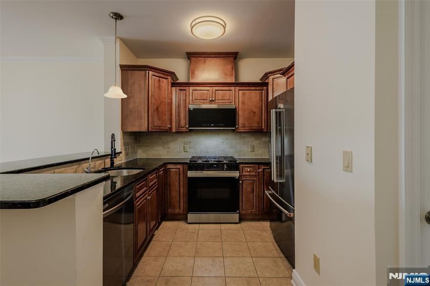 Welcome to Christie Riverfront Condos, located in the desirable Ironbound section of Newark. This beautifully renovated top-floor unit offers 3 bedrooms and 2 full bathrooms, combining modern upgrades with comfortable living.The home features brand-new stainless steel appliances, granite countertops, and refinished hardwood floors throughout. Enjoy 9-foot ceilings with elegant crown molding, creating a bright and spacious atmosphere. Additional highlights include central HVAC, in-unit stackable washer and dryer, and one assigned garage parking space.Ideally situated facing Riverfront Park and conveniently located near major highways, schools, shopping, and just blocks from Newark Penn Station and New Jersey Performing Arts Center.