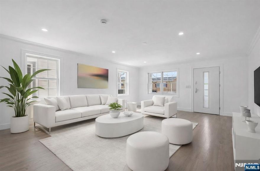 Welcome to this modern luxury two-family home featuring a side-by-side duplex design. Each unit mirrors the other and offers 3 spacious bedrooms, 2 full bathrooms, and 2 half bathrooms. The thoughtfully designed layout includes a butlerâ€™s room, formal dining room, modern kitchen, and bright living room. The home also features a versatile office/den that can easily be used as a home office, nursery, or additional flex space. Additional features include central vacuum and an outdoor sprinkler system for added convenience and easy lawn maintenance. The ground level features a beautiful open-concept family room with sliding doors leading directly to the backyard, perfect for entertaining or relaxing. This level also offers great potential for extended family living, providing additional flexible living space. Conveniently located close to NYC and within walking distance to transportation, schools, and restaurants, making commuting and everyday living easy. This property offers the perfect blend of modern luxury, space, and convenience, ideal for both owner-occupants and investors.